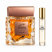 Nusuk Ateeq bottle with Wear This Next 10ml travel size on a clean white studio background
