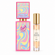 Lattafa Ajwad Pink to Pink Creamy Elixir bottle with Wear This Next 10ml travel size on a clean white studio background